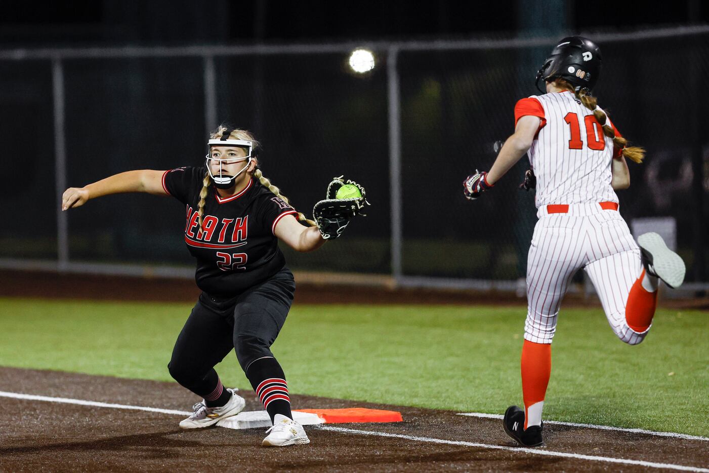 Rockwall-Heath senior first baseman Danielle Gillean (22) catches the throw to force out...