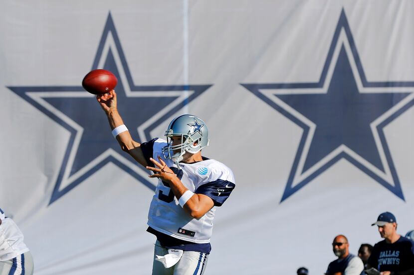 Dallas Cowboys quarterback Tony Romo (9) throws a pass during afternoon practice at training...