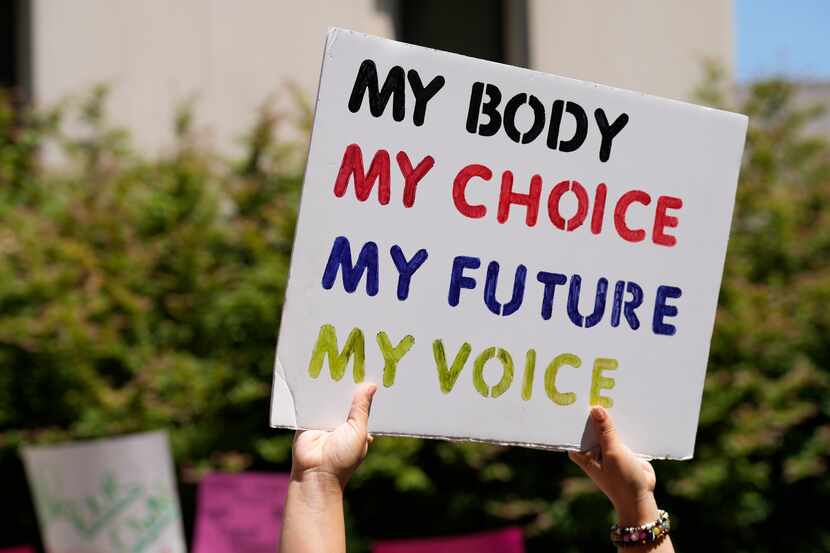 A woman supporting abortion rights holds a sign outside the South Carolina Statehouse in...