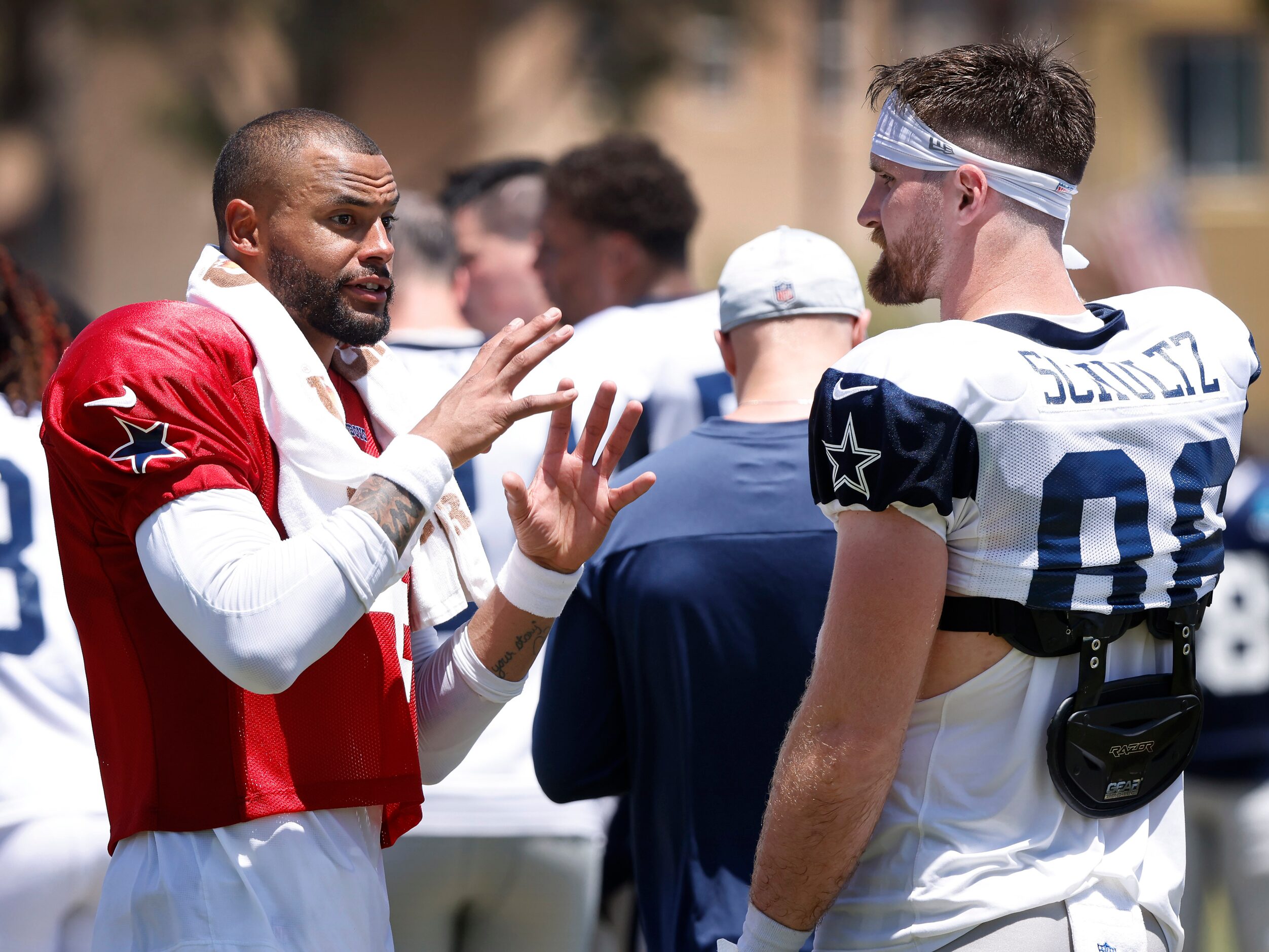 Dallas Cowboys quarterback Dak Prescott (4) confers with tight end Dalton Schultz (86)...