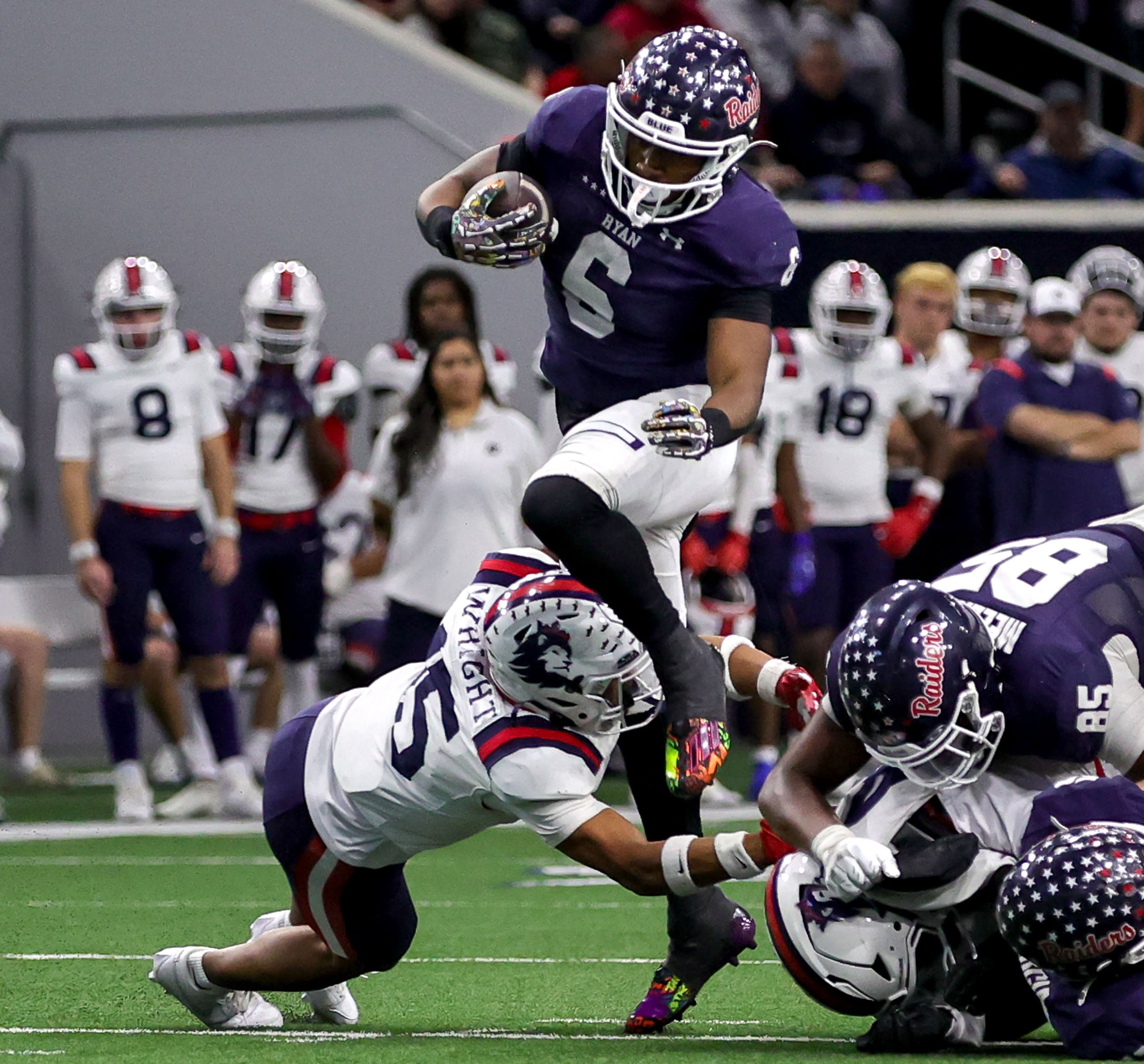 Denton Ryan running back Nemo Warmate (6) tries to break free from Richland defensive back...