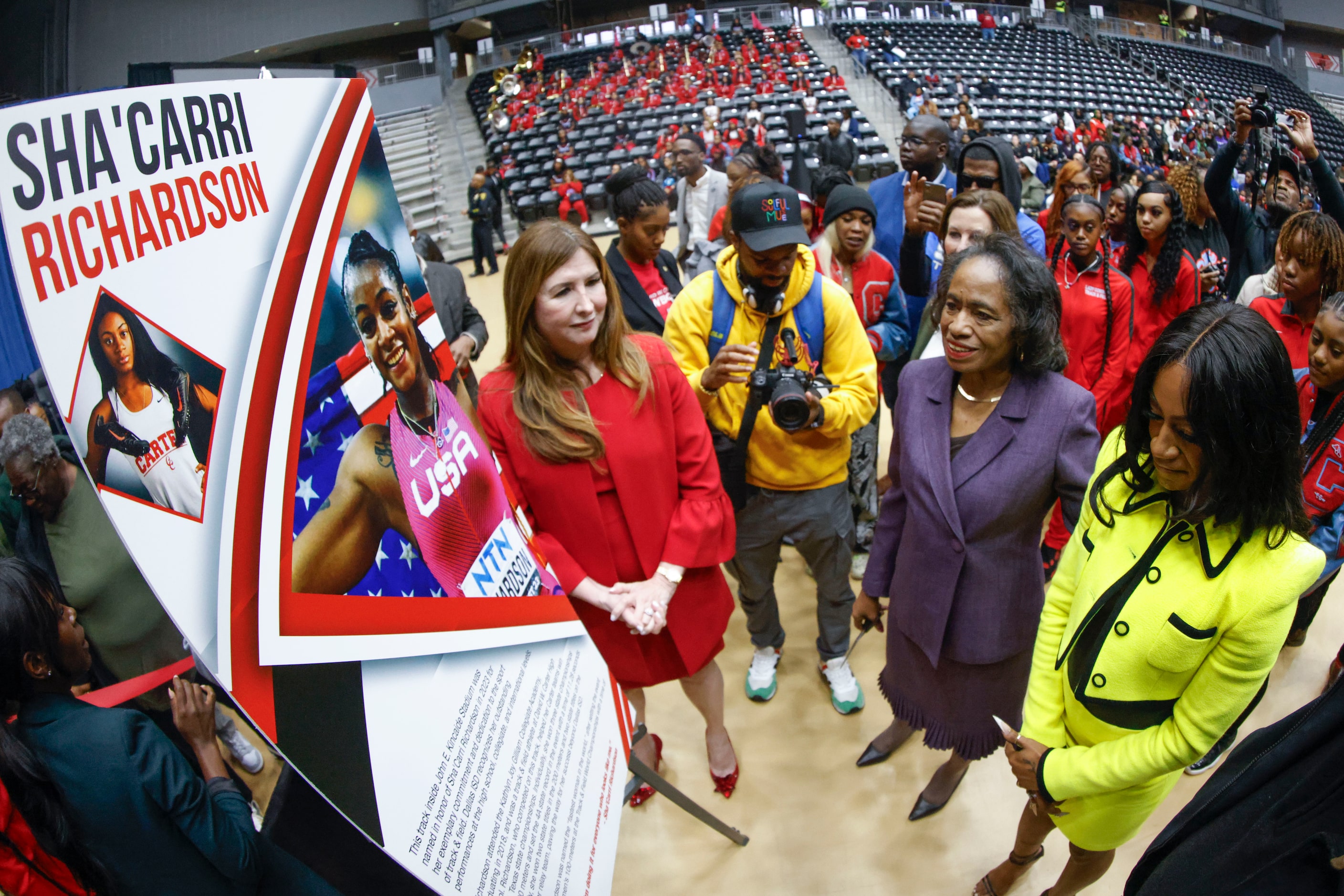 100 meters world champion Sha'Carri Richardson (right), reads the honorary plaque during a...