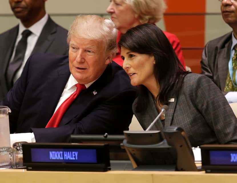 President Donald Trump speaks with U.S. Ambassador to the United Nations Nikki Haley during...