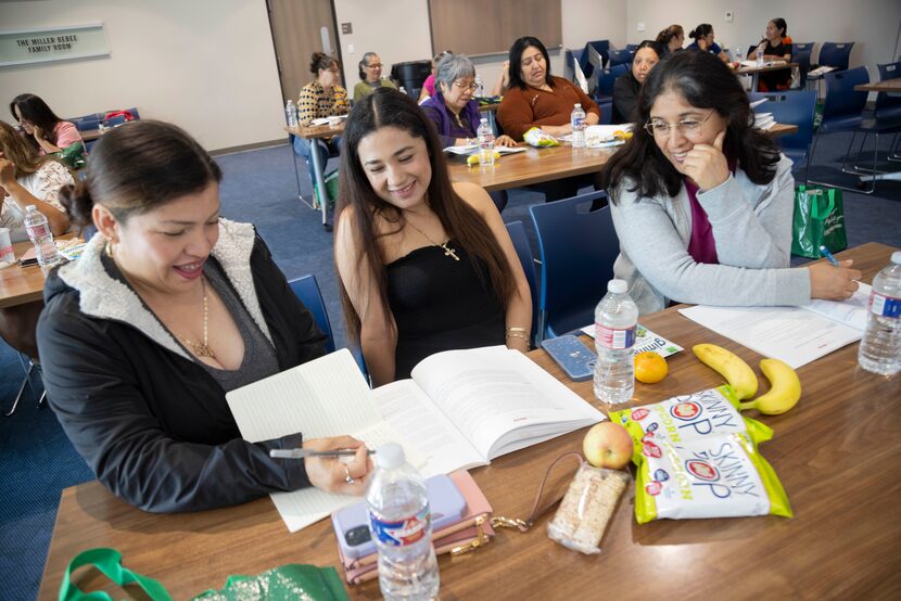 Perla Freyre (from left), Maria Sosa and Lucy Lerda chat during a small group discussion as...