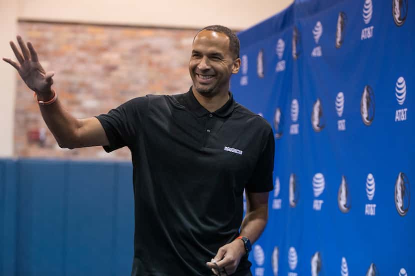 Dallas Mavericks General Manager Nico Harrison waves as he leaves a press conference in...