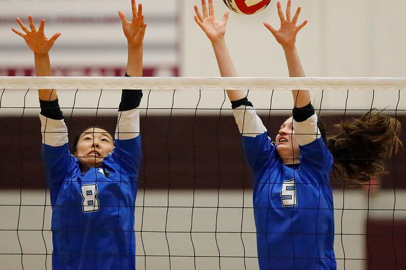 Plano West's Sydney Yap (8) and Hunter Anderson (5) attempt a block during Tuesday's...