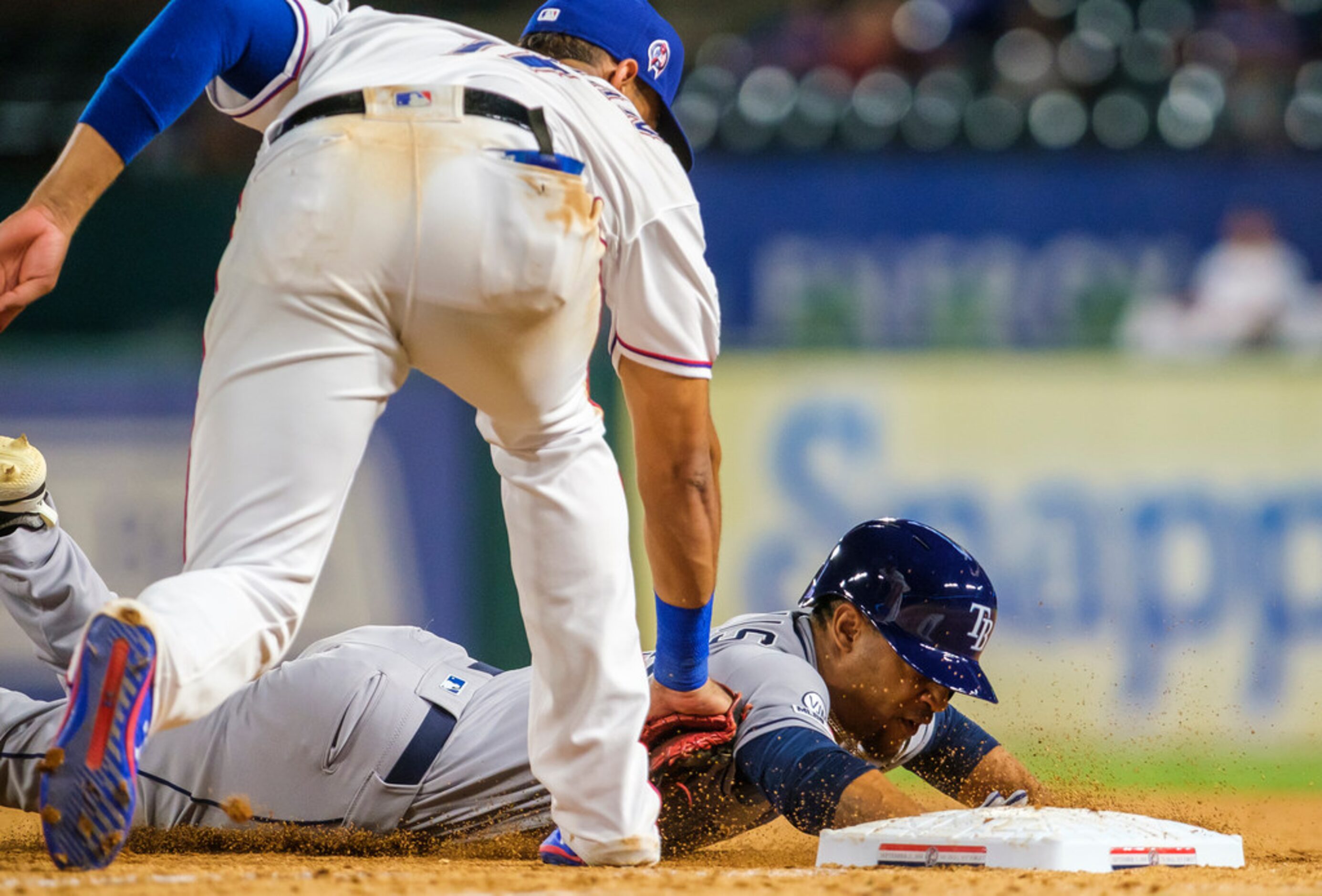 Tampa Bay Rays pinch runner Johnny Davis gets picked off first base as Texas Rangers first...