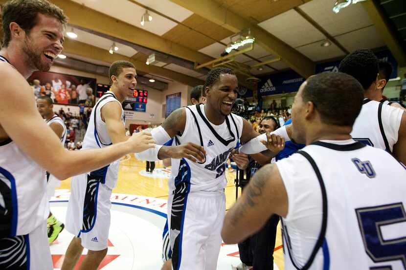 Chaminade's DeAndre Haskins, center, celebrates with teammates after their 86-73 win over...