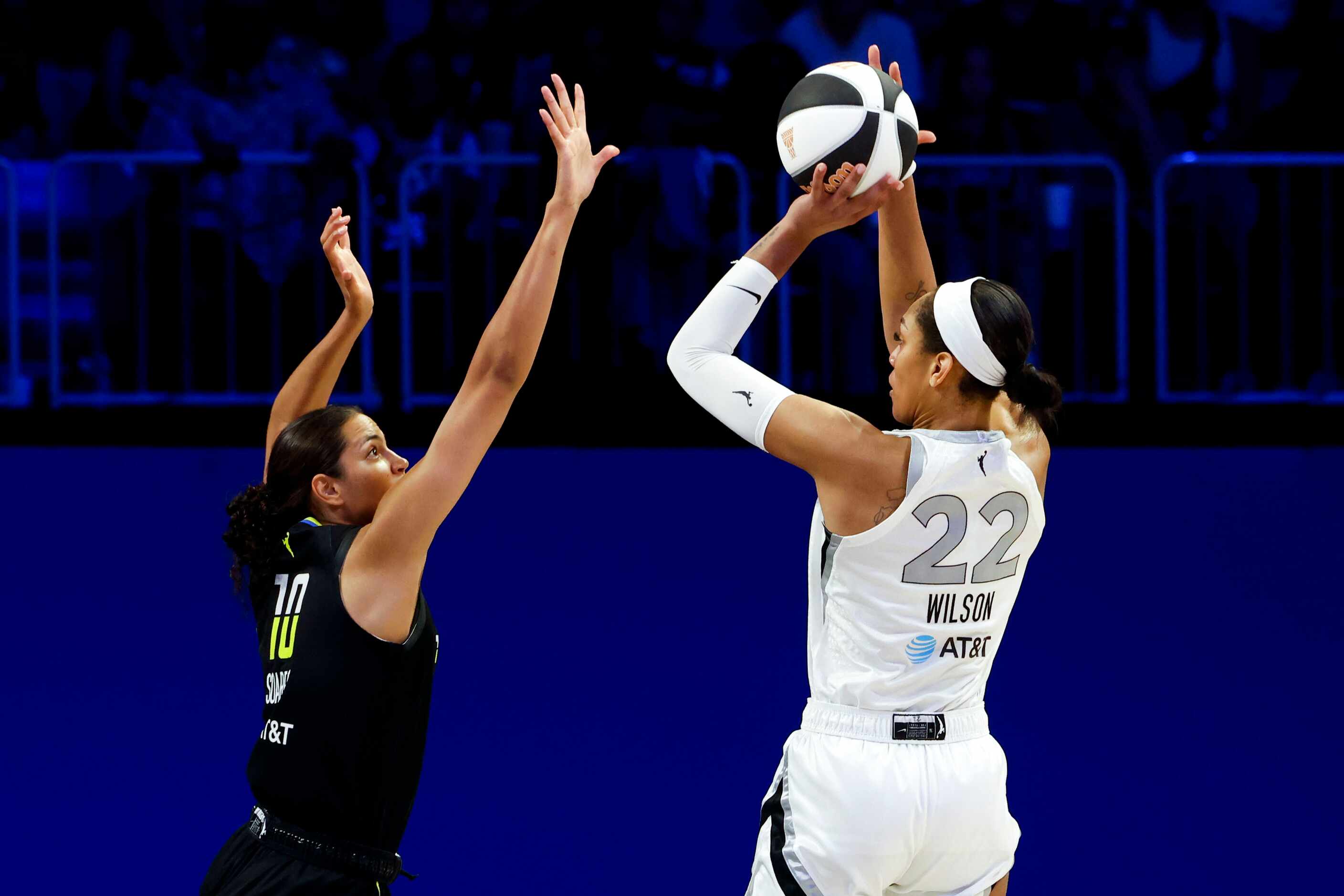 Dallas Wings center Stephanie Soares (left) reaches to block a three-point of Las Vegas Aces...