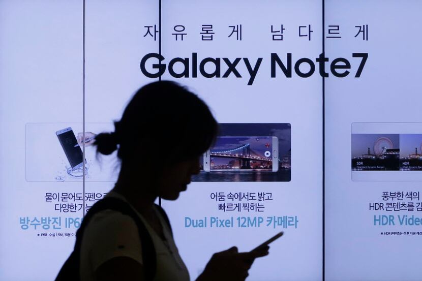 A woman walks by an advertisement of Samsung Electronics Galaxy Note 7 smartphone at the...