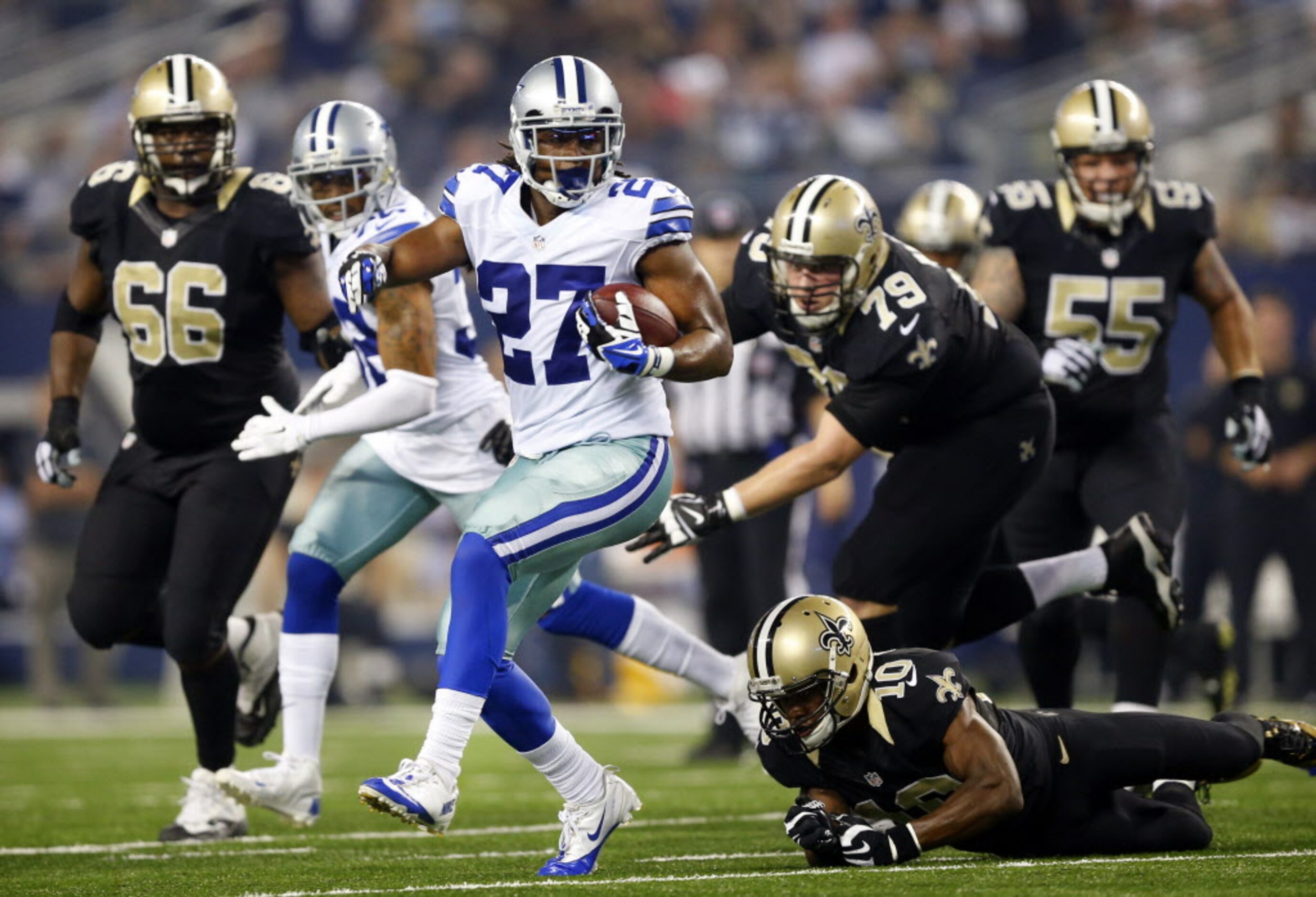 Dallas Cowboys strong safety J.J. Wilcox (27) races with the football after recovering a...