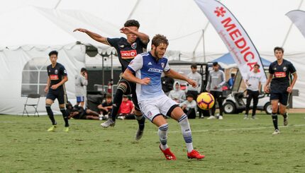 Tanner Tessmann controls the ball while shielding off a North Carolina FC defender in the...