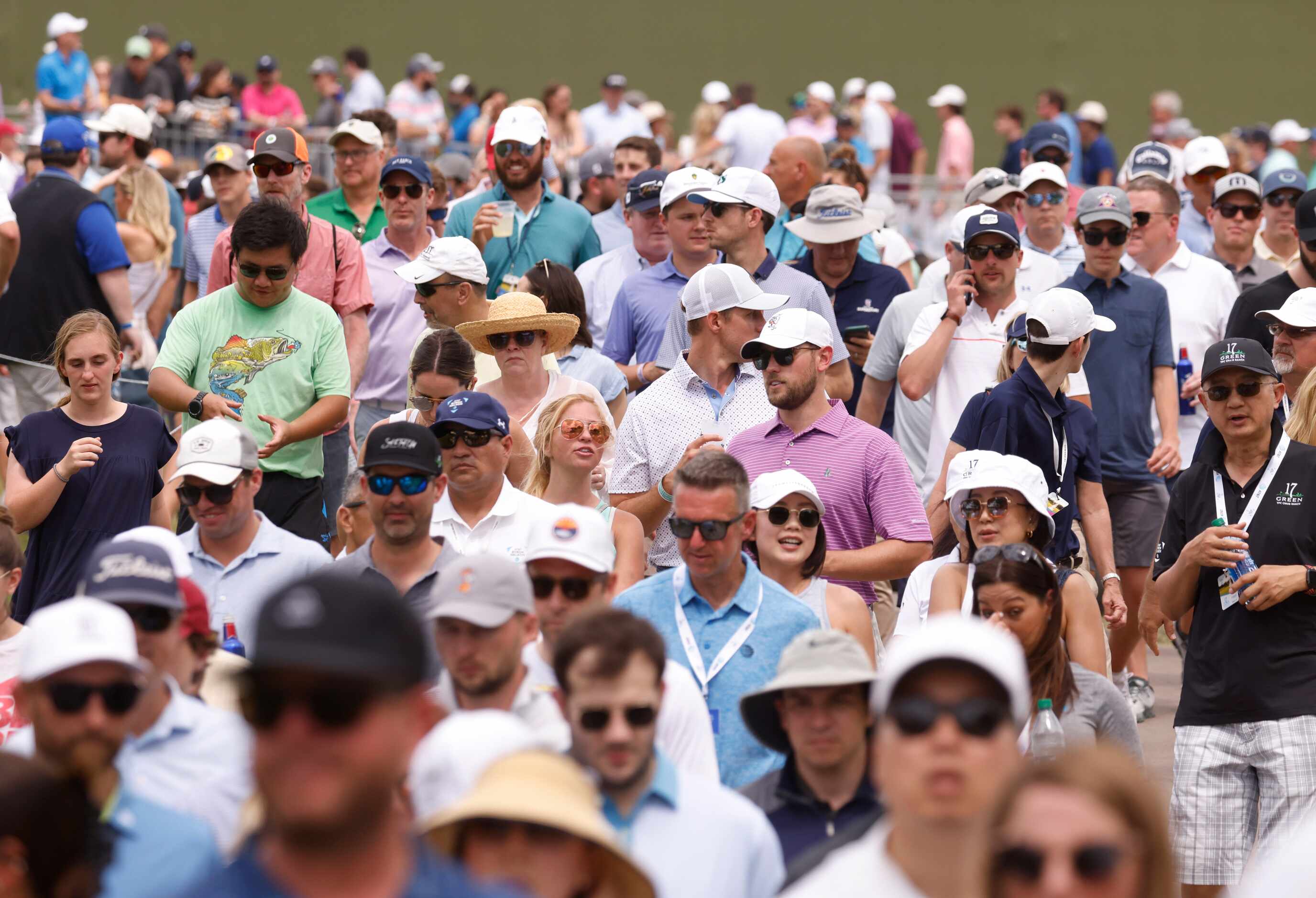 Fans make their way towards the green after watching Jordan Spieth tee off on the 13th hole...