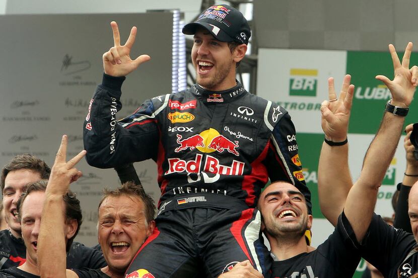German Formula One driver Sebastian Vettel (C) celebrates his F-1 World Championship with...