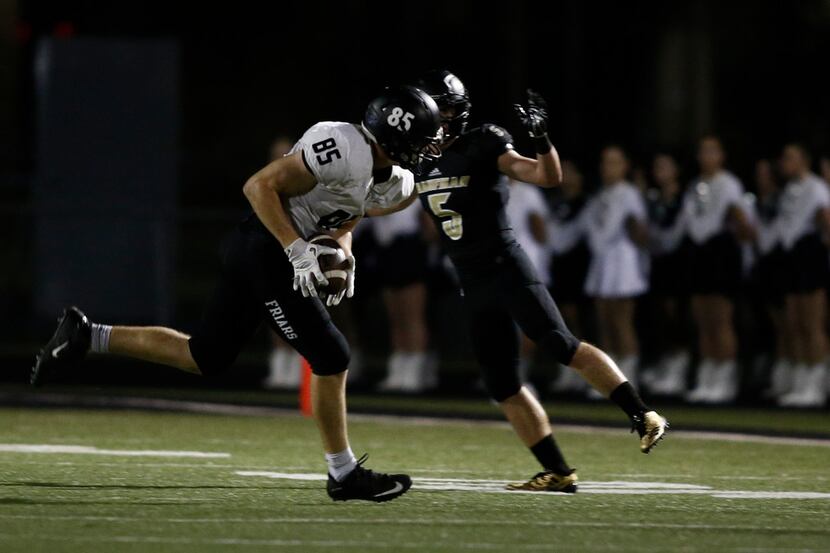 Bishop Lynch's Jack Bradley (85) hauls in the pass as Kaufman's Michael Glick (5) defends in...