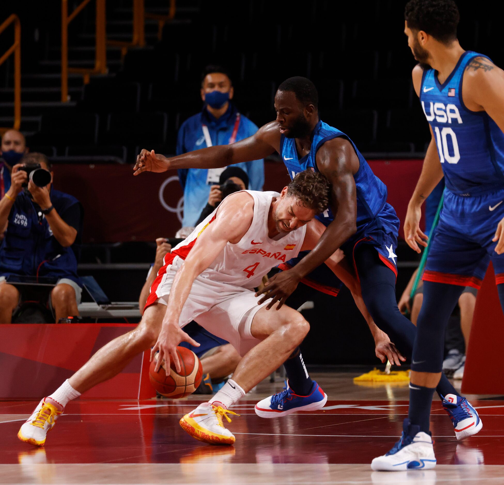 Spain’s Pau Gasol (4) falls as he is defended by USA’s Draymond Green (14) during the first...