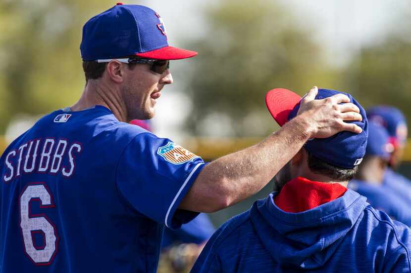 Texas Rangers outfielder Drew Stubbs pats second baseman Rougned Odor on the head during a...