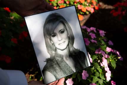 Robert Baker holds a photo of his late wife, Leslie Squair Baker, in his backyard on Friday,...