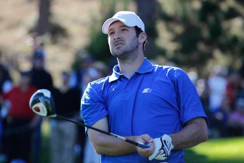 The Dallas Cowboys' Tony Romo watches his tee shot on the 11th hole at Spyglass Hill Golf...