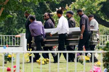 Pallbearers carry the caskets of Amaya Lockett, 24, and Jalisa Lockett, 22, to their burial...