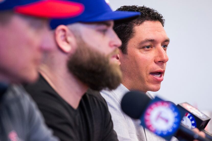 Texas Rangers general manager Jon Daniels, right, speaks during a press conference...