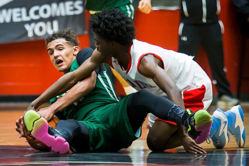 Skyline's Treyvon Watts-Hale (right) fights for a loose ball with Norman North's Trae Young...