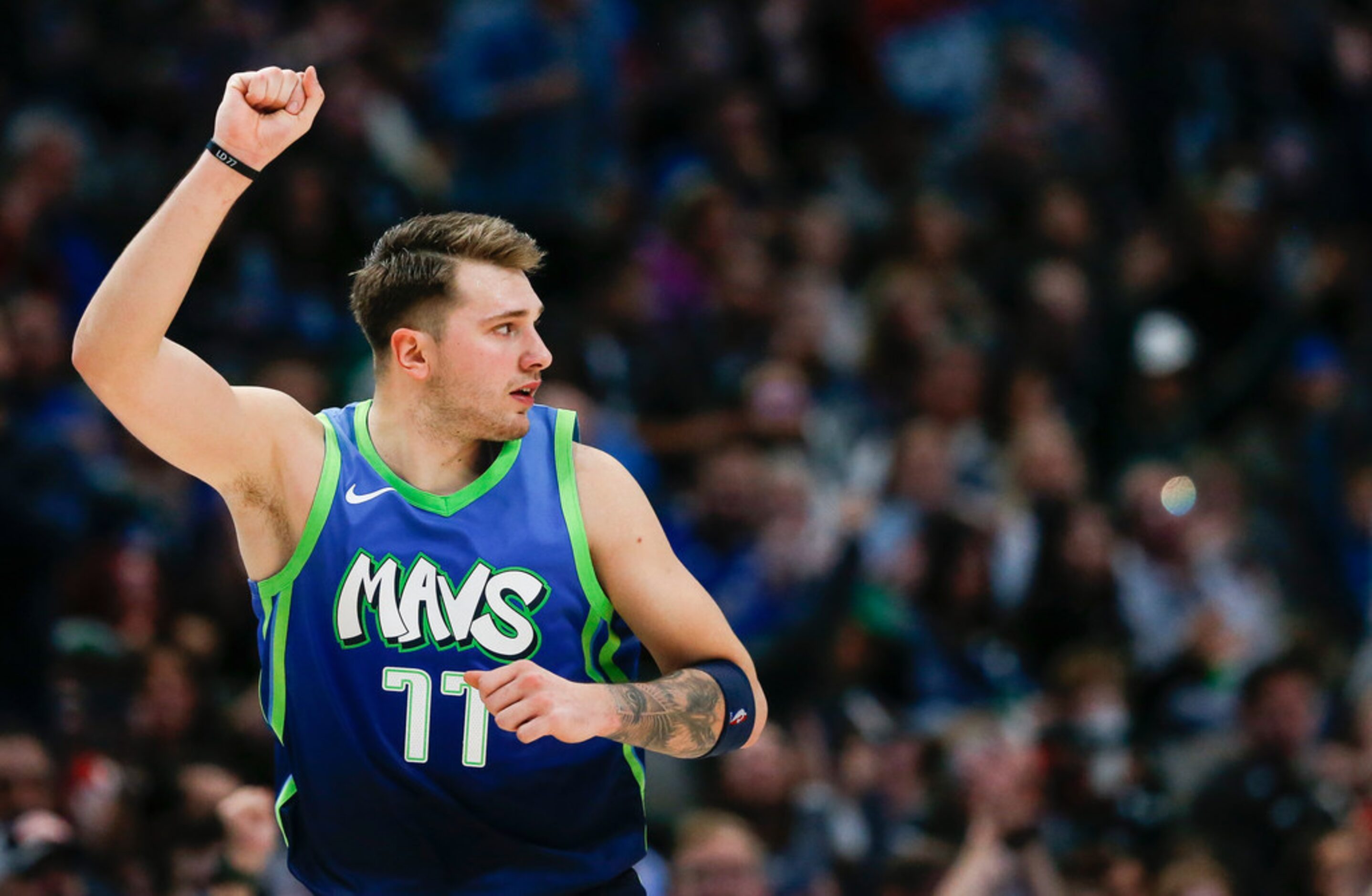 Dallas Mavericks forward Luka Doncic (77) celebrates sinking a three pointer during the...