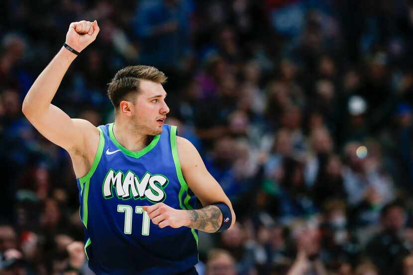 Dallas Mavericks forward Luka Doncic (77) celebrates sinking a three pointer during the...