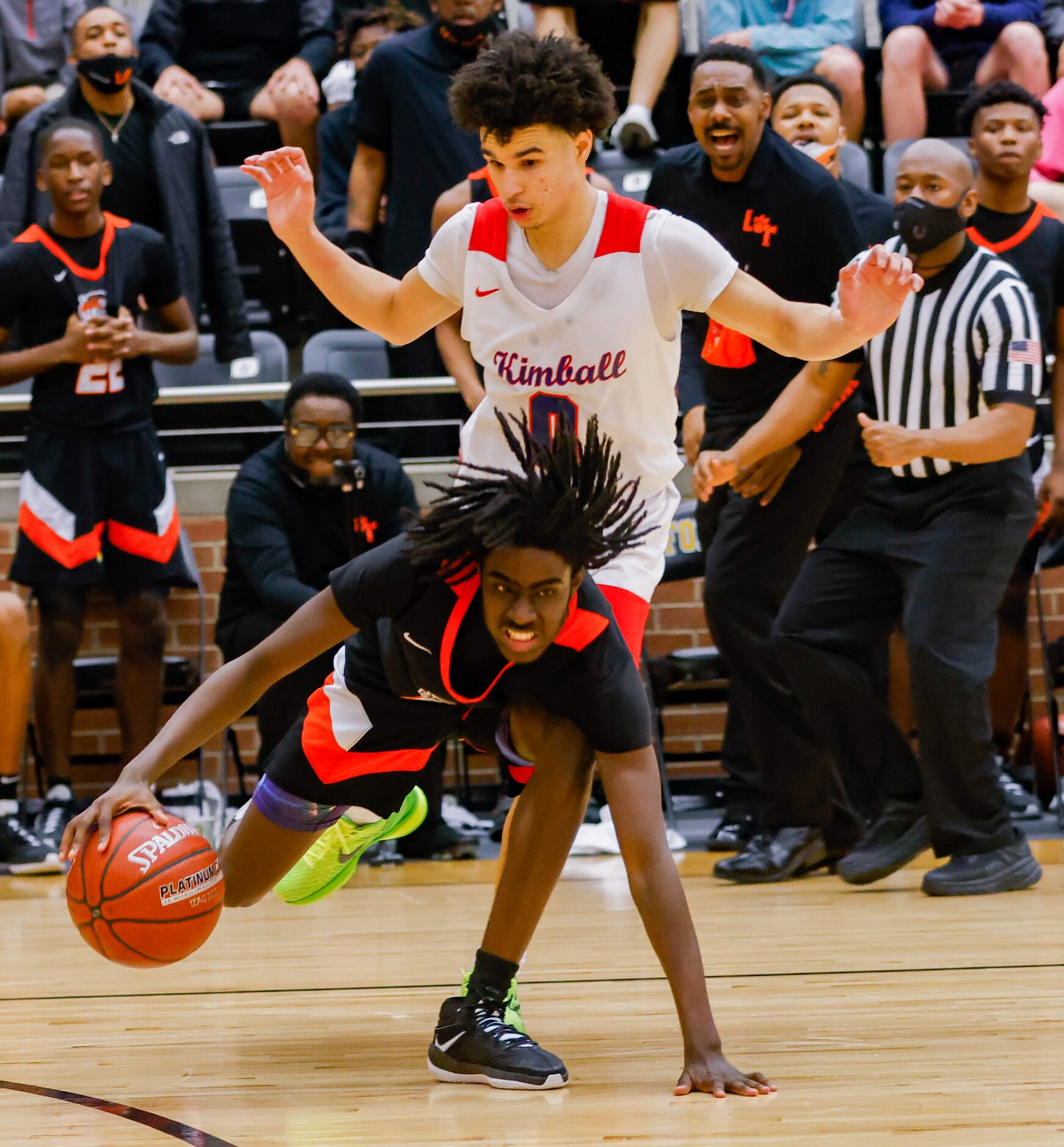 Lancaster's Jarod Johnson (12) falls over Kimball's Jayden Blair (0) during the overtime of...