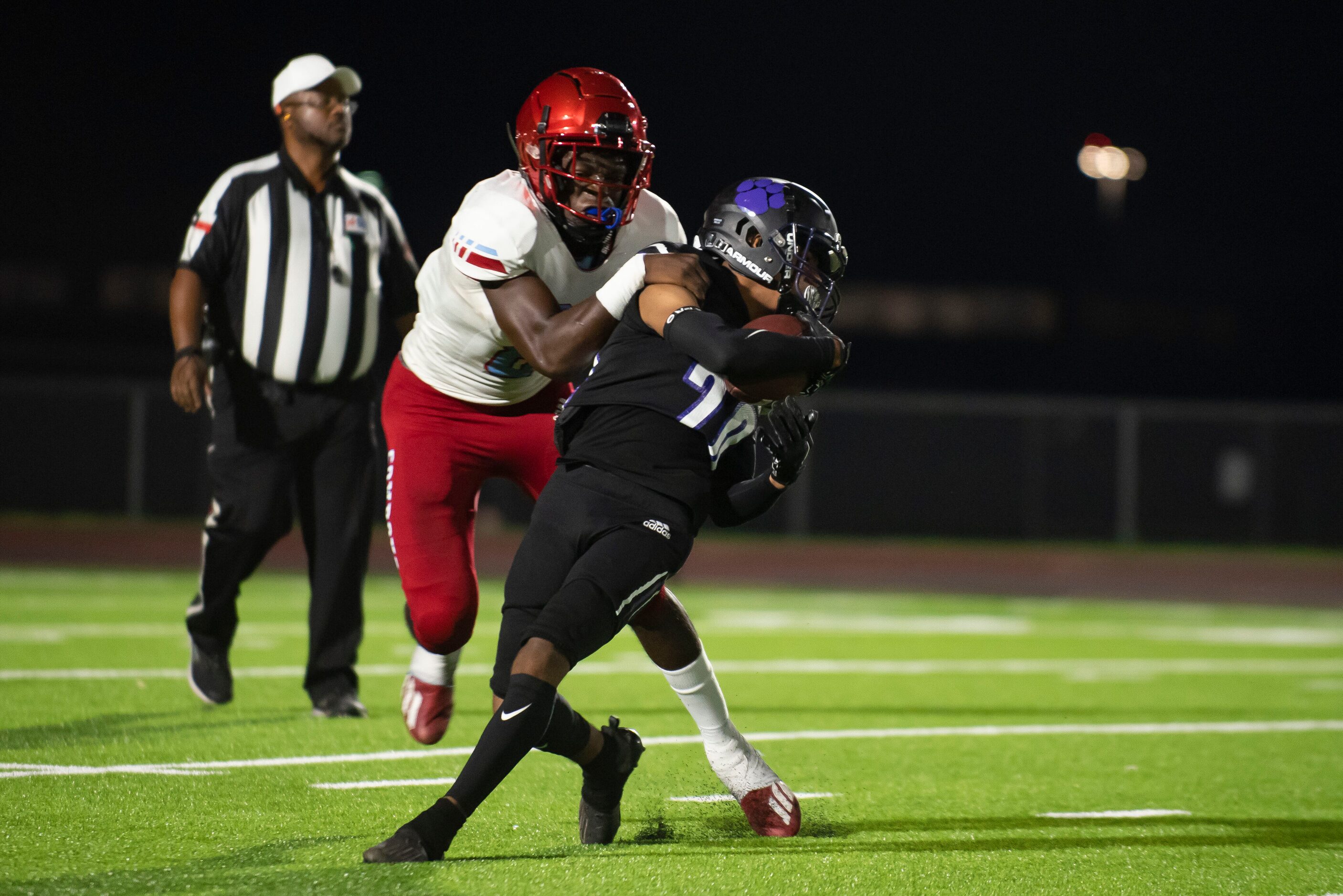 Carter senior Diontre Webber (8) tackles Lincoln senior Drevion Washington (20) during a...