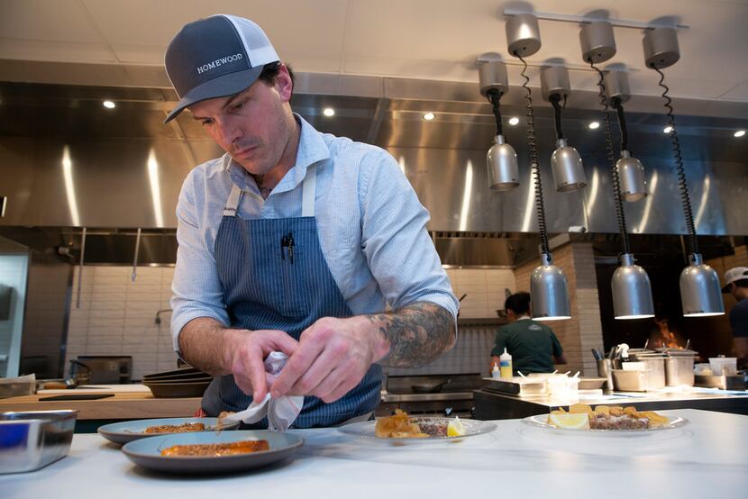 Chef Matt McCallister finishes a dish in the open kitchen.