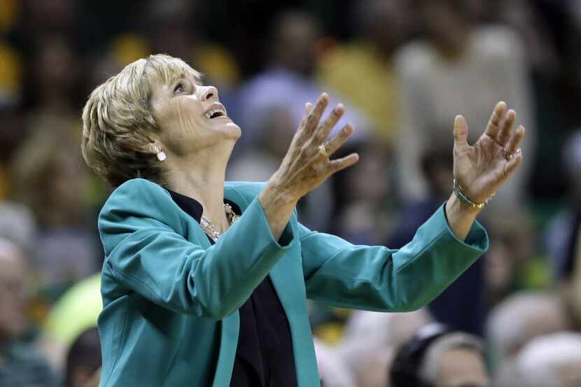 Baylor head coach Kim Mulkey throws her hands up after her team was charged with a foul in...