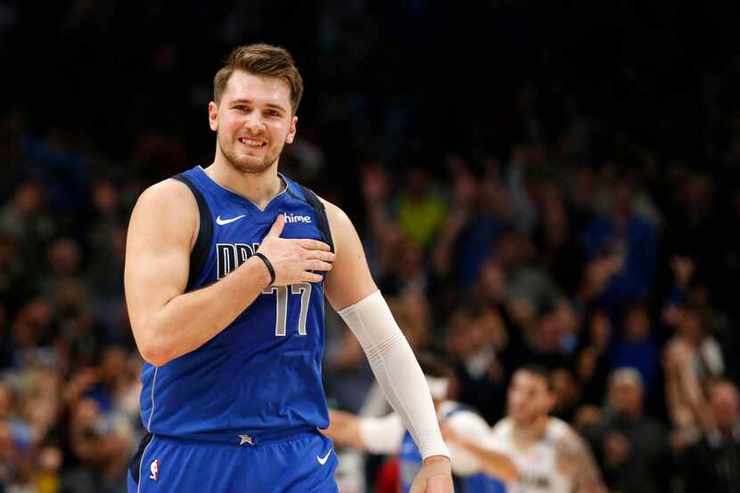 Dallas Mavericks guard Luka Doncic (77) taps his chest after making a three pointer late in...