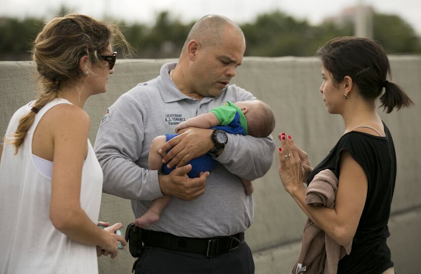 Miami-Dade Fire paramedic lieutenant Alvaro Tonanez helps rescue 5-month-old Sebastian de la...