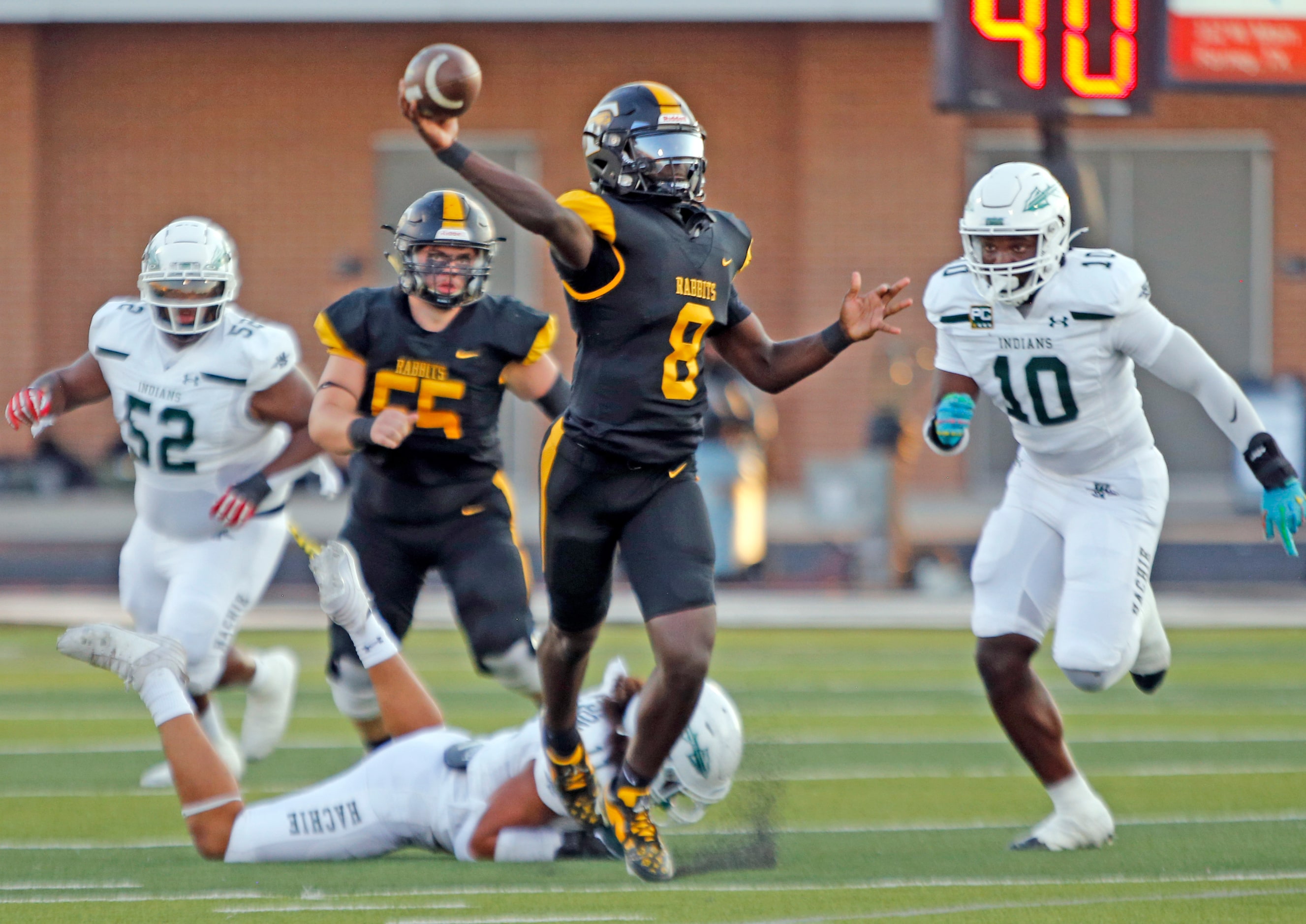 Forney high QB Nelson Peterson, Jr. (8) throws a pass on the run during the first half of a...