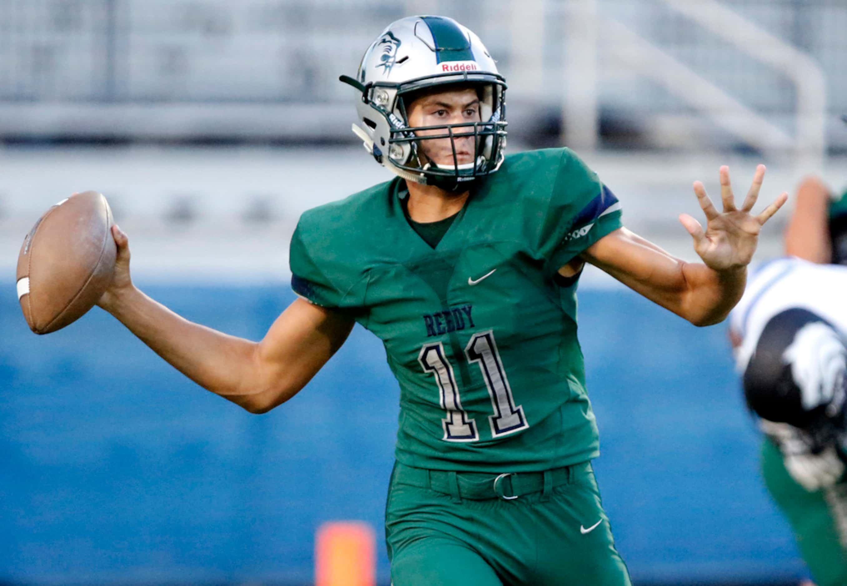 Reedy High School quarterback Jalen Kitna (11) throws a pass during the first half as Reedy...