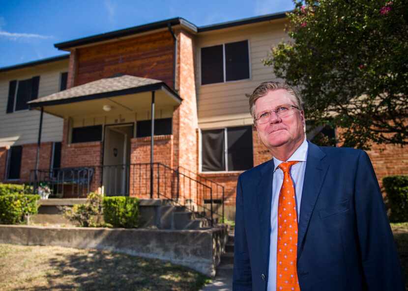 Developer Ruel Hamilton stands next to a renovated building at Good Haven Apartments, one of...