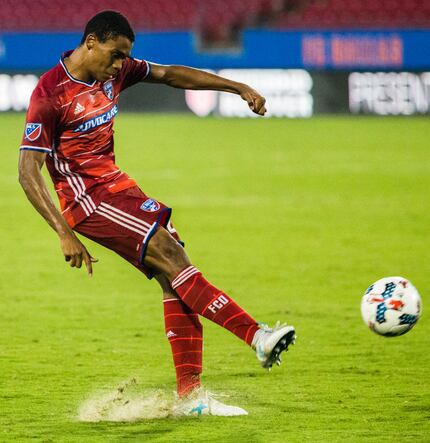 FC Dallas defender Reggie Cannon (22) takes a shot during the second half of an MLS soccer...