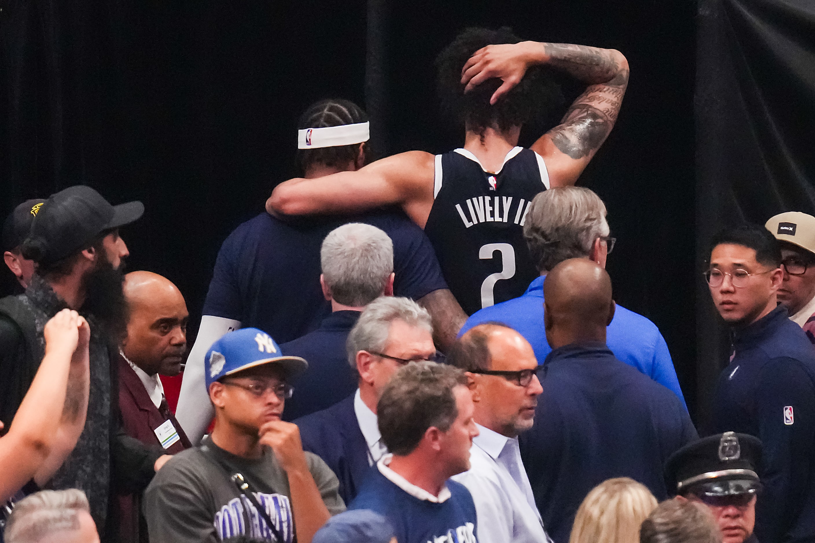 Dallas Mavericks center Dereck Lively II (2)leaves the court after being injured during the...