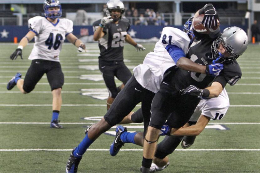 Denton Guyer's Conner Crane (10) fights for the goal line to score on a first-quarter pass...