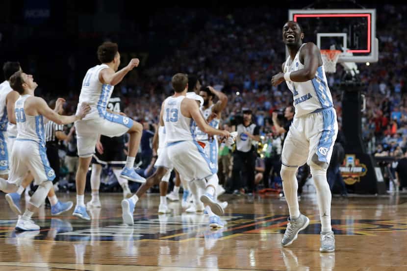 North Carolina forward Theo Pinson, right, celebrates at the end of the championship game...