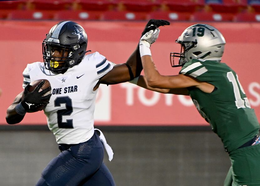 Frisco Lone Star’s Ashton Jeanty (2) runs through a tackle attempt by Frisco Reedy’s Connor...