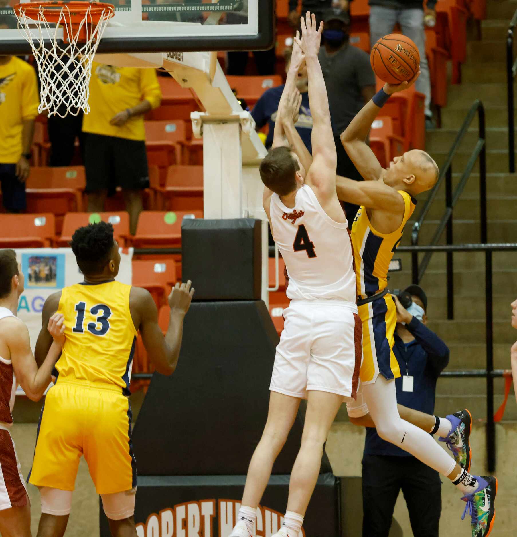 Faith Family’s Jordan Walsh makes a basket while being guarded by Argyle’s Nate Atwood (4)...