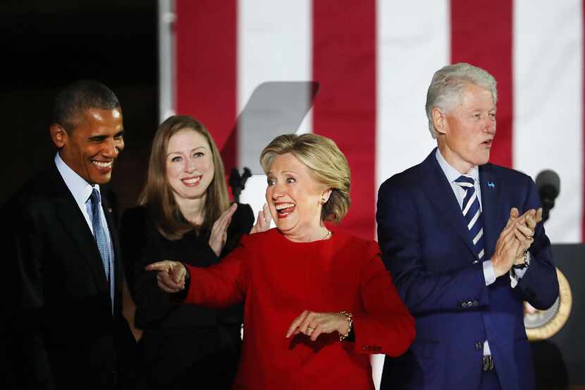 Hillary Clinton stands with President Barack Obama, former President Bill Clinton and...
