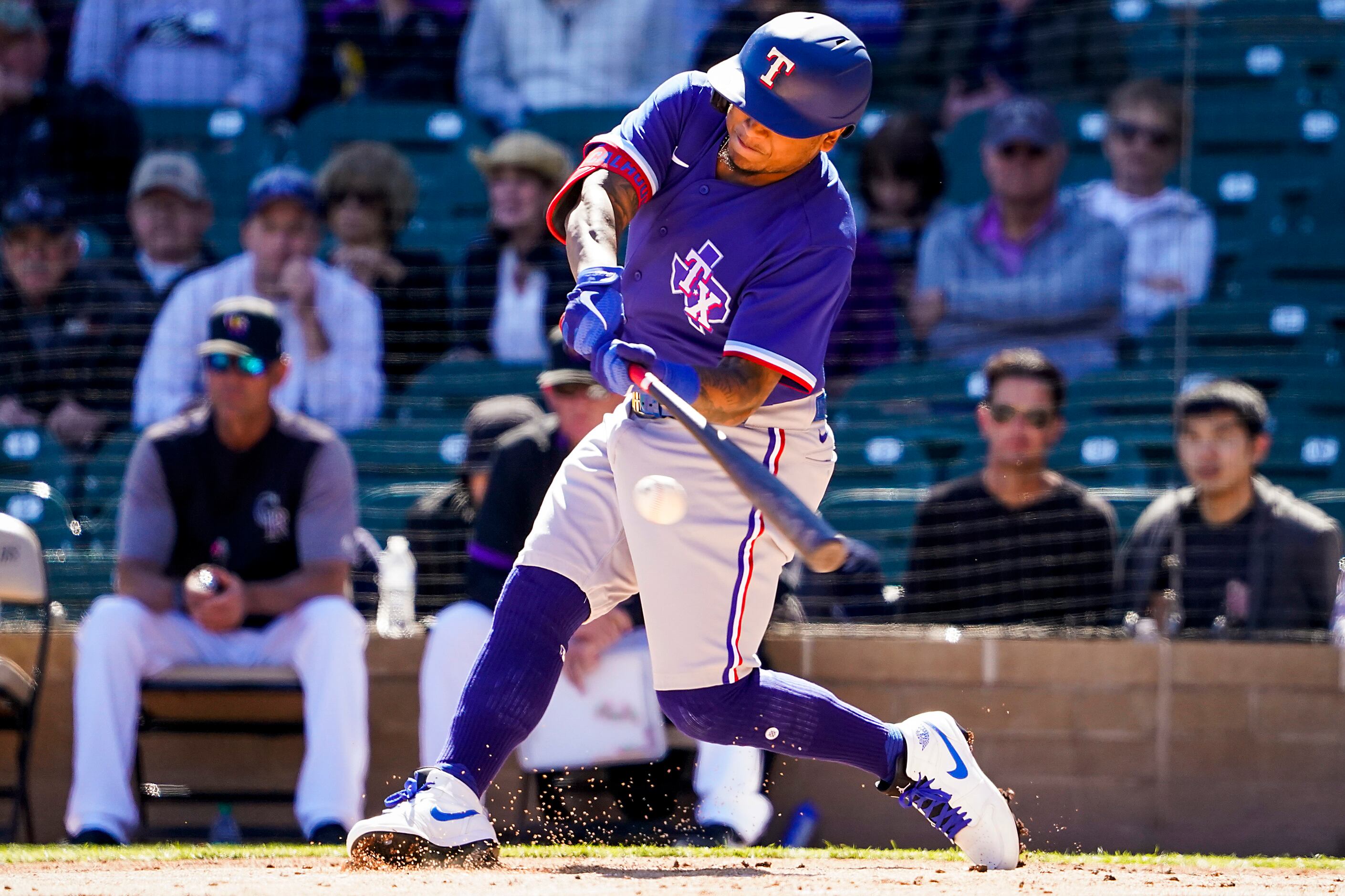 Texas Rangers outfielder Willie Calhoun bats during the first inning of a spring training...