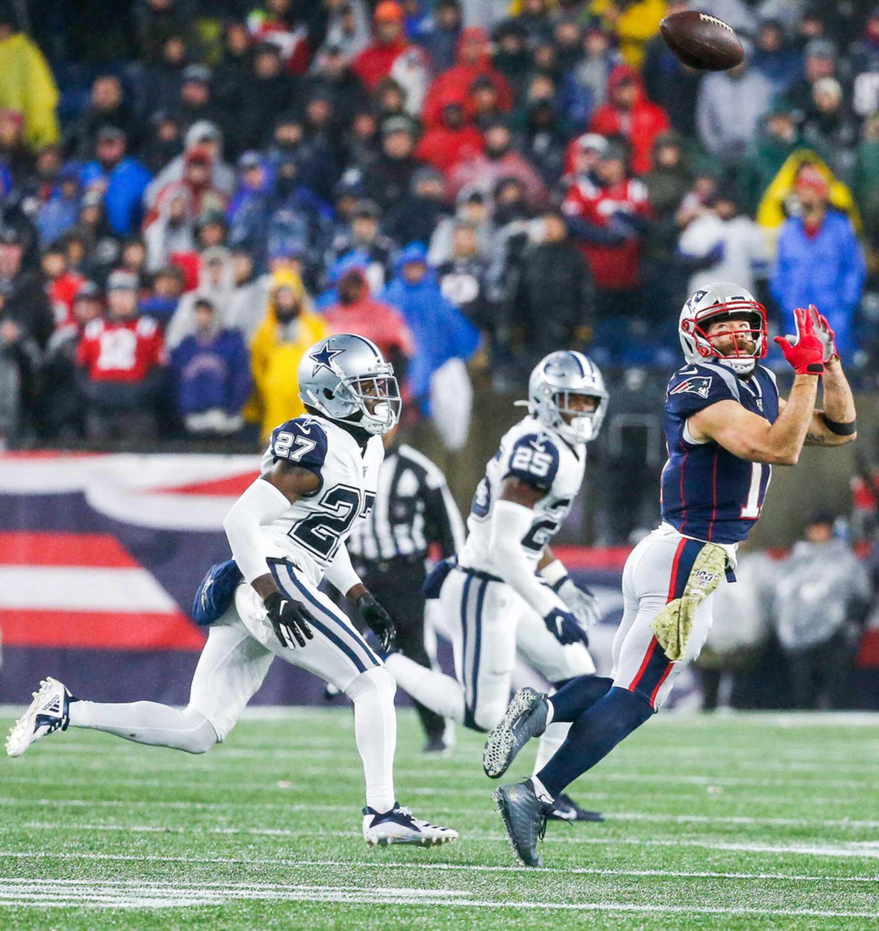 New England Patriots wide receiver Julian Edelman (11) makes a reception over Dallas Cowboys...