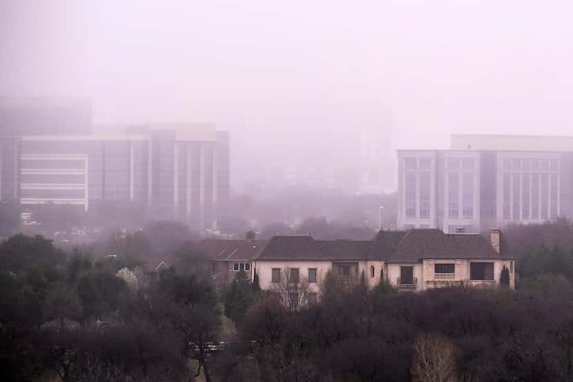Buildings in the Hall Office Park rise over homes in the Stonebriar Creeks Estate...