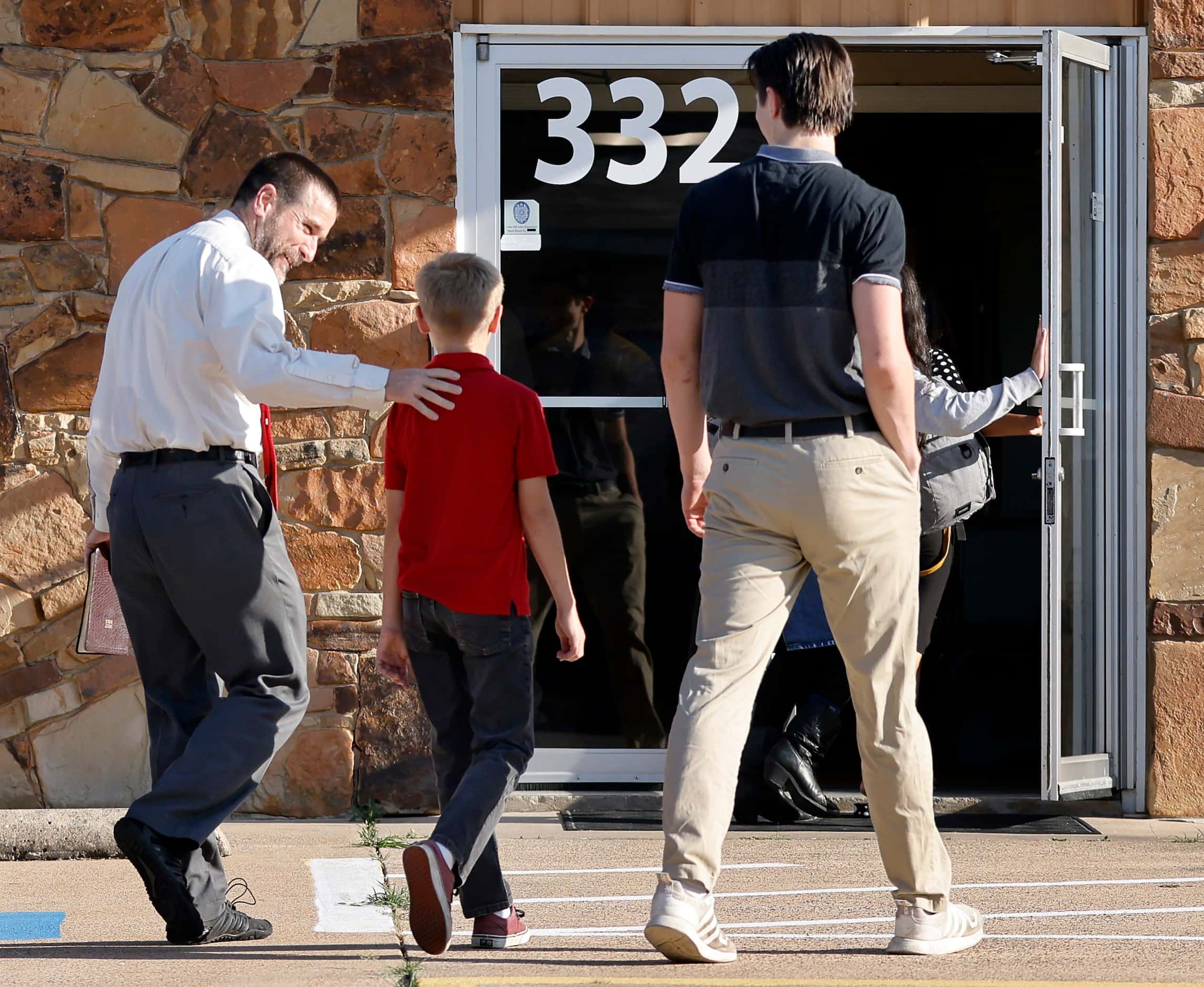 New Independent Fundamentalist Baptist founder Steven Anderson puts his arm around a boy as...