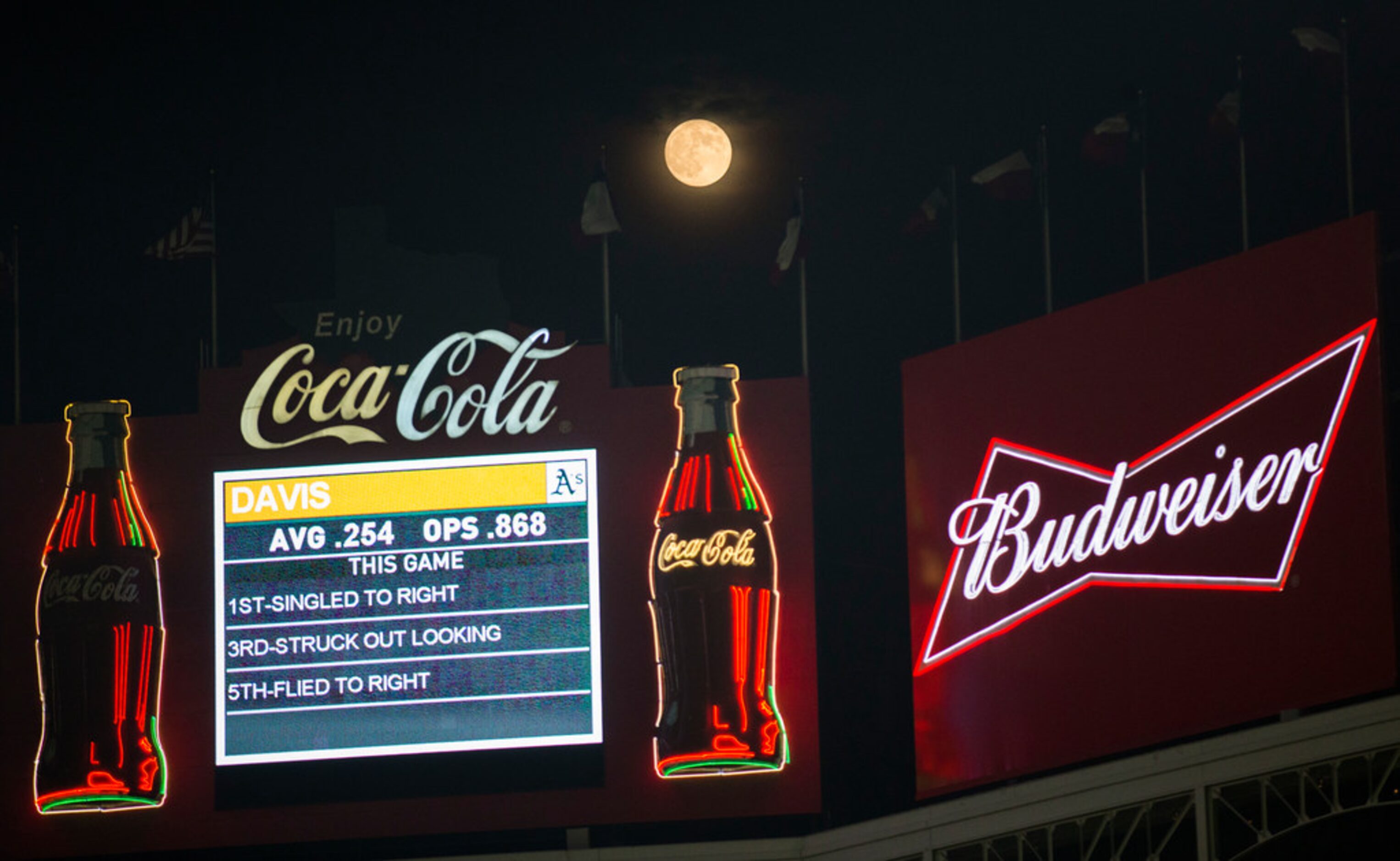 A full moon rises over center field during the seventh inning of an MLB game between the...