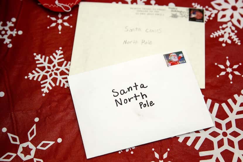 Letters written to Santa rest on a table after being opened by United States Postal Service...